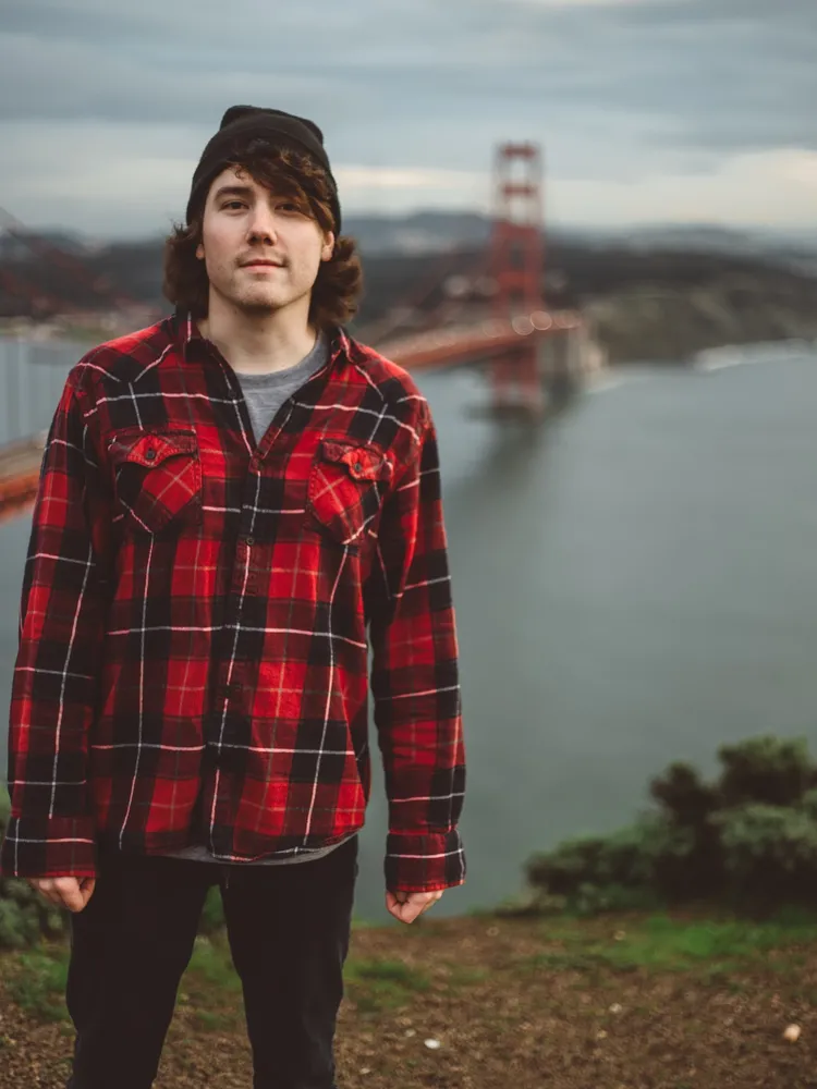Alex in a red flannel in front of the Golden Gate Bridge